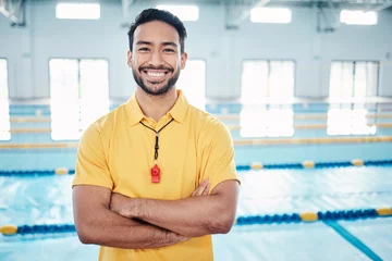 Rolgordijnen Portrait, proud and coach at a swimming pool for training, exercise and practice at indoor center. Face, happy and personal trainer ready for teaching, swim and athletic guidance, smile and excited © Clayton D/peopleimages.com