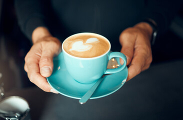 Barista hands, coffee and foam heart for customer, waiter working and server in small business restaurant. Man, creative shape in cappuccino or milk latte mug from espresso machine in cafe shop