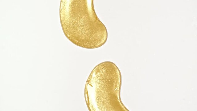 Golden patches for the eyes and facial mask for skin care Isolated on white background. Women's cosmetics skincare. Sample of packaging for design, beauty product, advertising.4k. High quality 4k 
