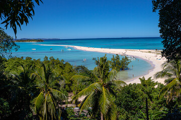 Nosy Iranja: a tropical island paradise off Madagascar's coast w/ turquoise waters, coral reef, white sand beaches & lush vegetation.