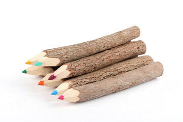 Colorful crayons made of rough and unprocessed wood isolated on white
