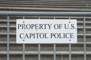 Washington D. C., USA - 09 11 2022:  Plate with inscription "Property of U. S. Capitol Police" on a protective fence in front of the stairs of the U. S. Capitol in Washington D. C.