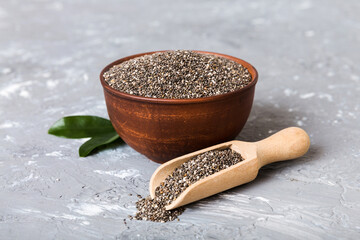 Chia seeds in bowl and spoon on colored background. Healthy Salvia hispanica in small bowl. Healthy superfood