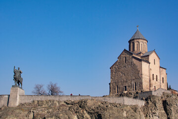 Fototapeta na wymiar Tbilisi, Georgia - january 23 , 2023: Metekhi Church and Monument of King Vakhtang I Gorgasali in Tbilisi