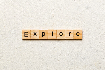 Explore word written on wood block. Explore text on cement table for your desing, concept