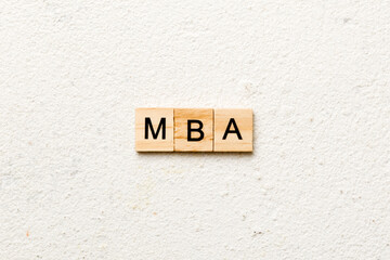 MBA word written on wood block. Master of Business Administration text on table, concept
