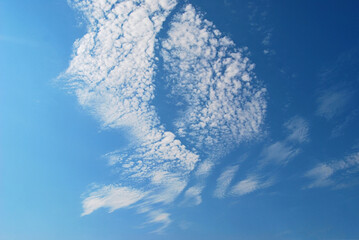 A background of a clear blue sky with clouds