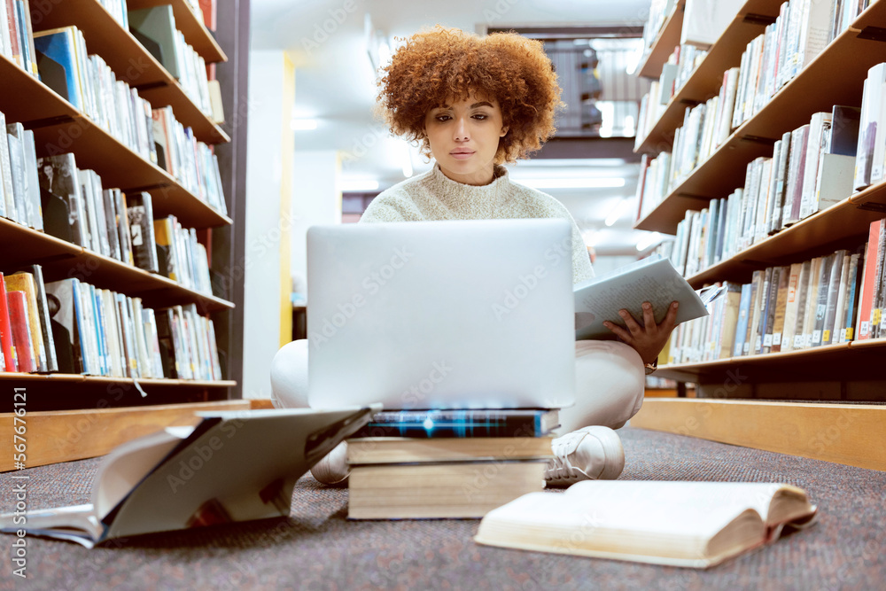 Aufkleber college library learning, laptop and black woman student working on the floor with books. reading, c