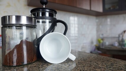 concepts and ideas coffee cups, coffee powder in glass bottles and coffee pot in the kitchen bar counter    