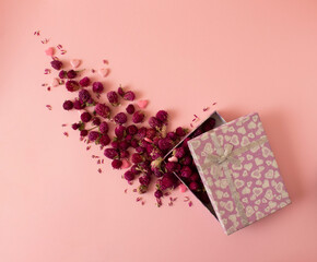Creative layout made of flowers flowers and pink harts bloom out of the box. Flat lay bouquet. Love concept.