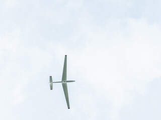 Small private propeller airplane pulling glider airplane in the sky
