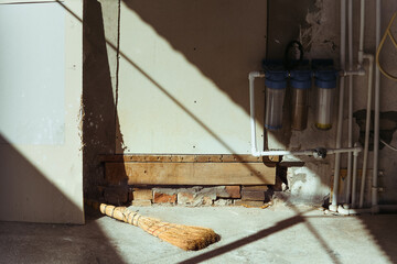 Broom laying on the floor in a room