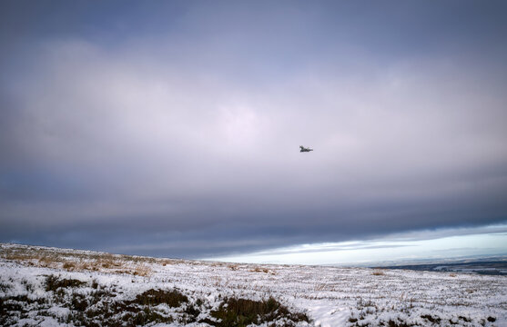 A low flying FGR4 Typhoon combat fighter training over the moors near Blanchland, Northumberland, England UK.