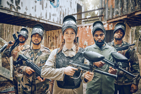Paintball, team portrait and woman leader with gun for sports game, competition or action challenge. Diversity men and female group for military, soldier or army mission in outdoor war battlefield