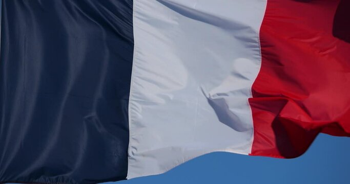 The french national flag waving in the wind.