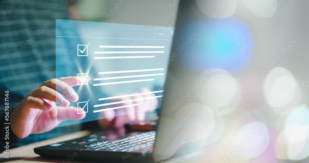 Poster Checklist on Digital system. Digital work checklist on virtual screen concept, Businessman use a pen point on checklist and use laptop working in office Document Management. efficiently manage file.