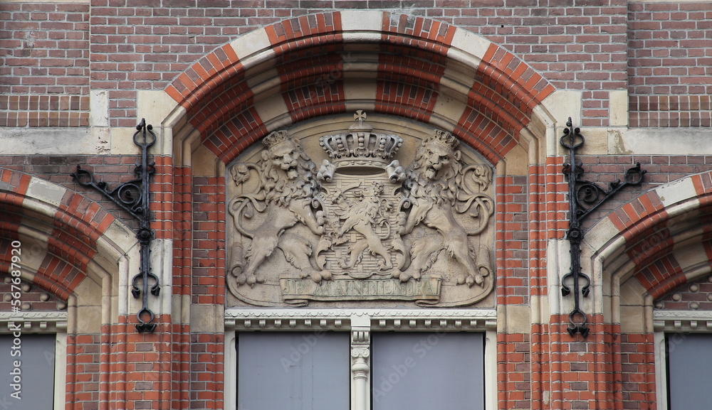 Wall mural amsterdam historic bushuis building facade detail with sculpted dutch coat of arms, netherlands