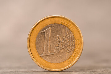 Close-up of one Euro coin on the grey stone background