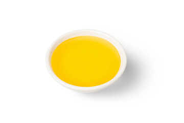 Isolated Honey bee in white bowl and linden glower on white background.