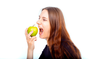 Pregnant woman propose apple for her belly copy space. Beautiful expectant lady having fresh snack, gray studio background. Healthy nutrition and pregnancy concept, copy space