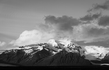 Majestic mountain shrouded in clouds - a timeless masterpiece in black and white, capturing the beauty and mystery of nature's grandeur.
