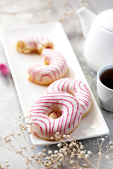 Sweet donuts with raspberries and strawberries. Tea drinking.