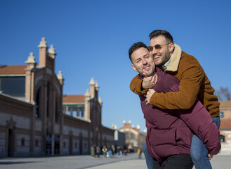 A portrait of happy gay couple outdoors
