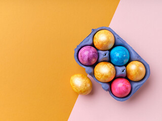 Flat lay with colored easter eggs on bright background. Creative template for festive content