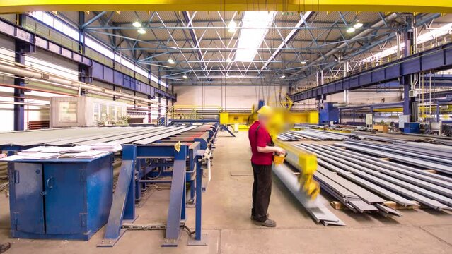 Factory workshop with lifting crane device timelapse hyperlapse, lift operator loads using lifting magnet, mechanical workshop, metal structures plant. Automated machine for precise metal cutting.
