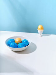Creative layout with colored easter eggs on bright background. A template for festive content