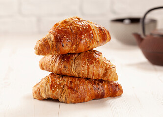 Three croissants one on top of the other,.