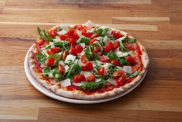 Pizza with cherrys, arugula and parmesan
