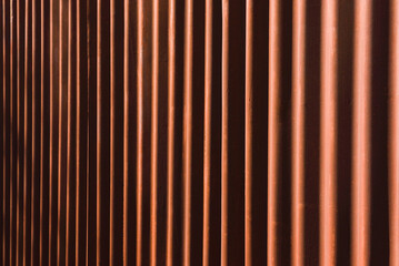 Background of vertical red and black stripes - the structure of a metal sheet