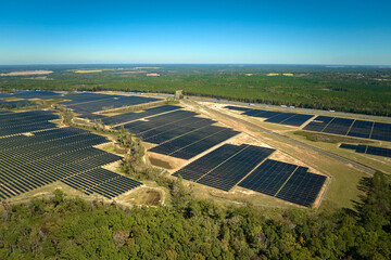 Aerial view of big sustainable electric power plant with many rows of solar photovoltaic panels for producing clean electrical energy. Renewable electricity with zero emission concept