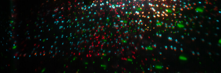 blurred rays of light on the disco floor. red green blue neon searchlight lights. laser lines and...