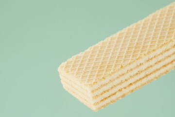 wafer cookies with white filling on a green background. close-up of a confectionery product. High quality 4k footage