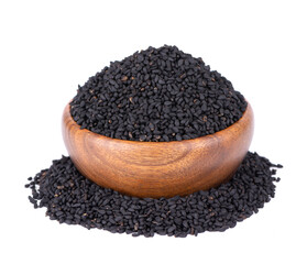 Black cumin seeds in wooden bowl, isolated on white background. Heap of black nigella seeds. Nigella sativa.