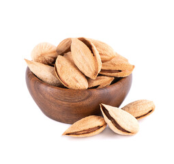 Mountain almonds in wooden bowl, isolated on white background. Uzbek wild almonds.