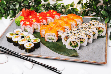 different sushi rolls on a big plate