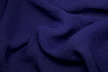 Blue fabric background. Blue cloth waves background texture. Blue fabric cloth textile material.