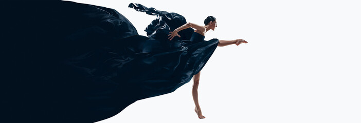 Expressive dane. Young woman, professional ballerina performing in black amazing dress over white background. Concept of art, beauty, dance aesthetics, choreography. Banner. Copy space for ad