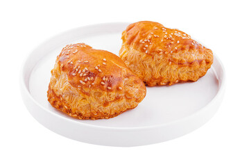 Puff pastry with sesame seeds on white plate