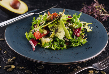fresh salad with avocado, lettuce, microgreen, cabbage, cucumber