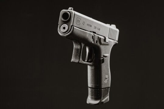 Brno, CZE - 8 24 2022: The Glock 42 is one smallest Glock pistol in caliber 380. Side view. Dark black background.