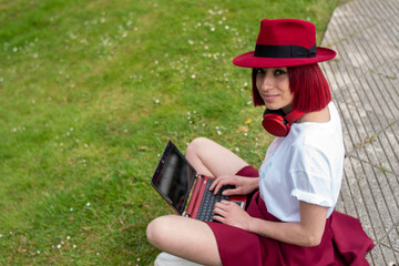 young redhead woman in red hat and red helmets