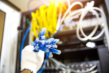 Hand choose lots of RJ45 UTP Cat6 LAN internet network cable fiber optic and Lots of Ethernet cables for connect computer and networking devices system to switch or hub modem router in rack cabinet.