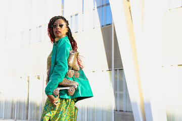 Urban woman enjoy outside. Modern woman posing with roller skates..