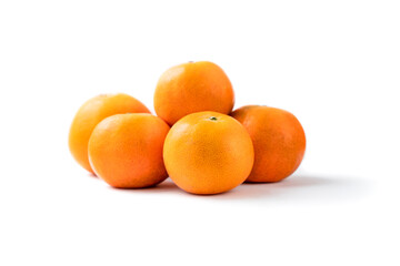 Closeup pile of fresh organic orange fruit on white background.