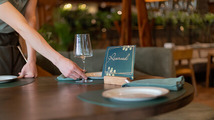 Cafe reserved table sign with wine glasses. Waiting for customers.