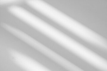 Gray shadow and light blur abstract background on white wall  from window. Dark stripe grey shadows indoor in room  background, monochrome, shadow overlay effect for backdrop and mockup design